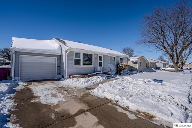 ranch-style home with a garage and driveway