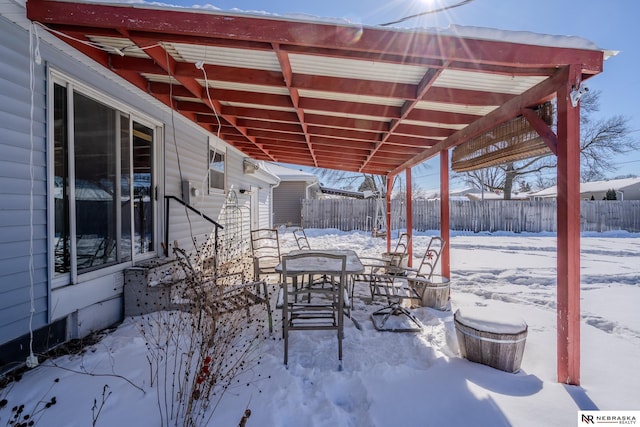 snow covered patio with fence