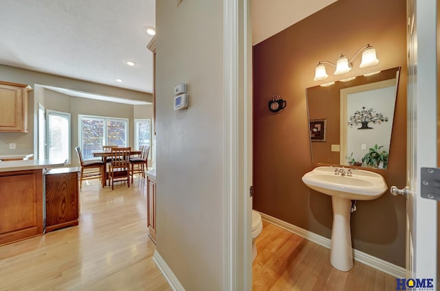 bathroom with toilet and hardwood / wood-style flooring