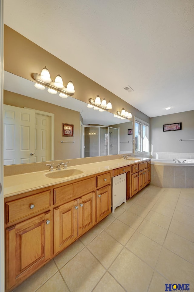 bathroom with plus walk in shower, tile patterned floors, and vanity