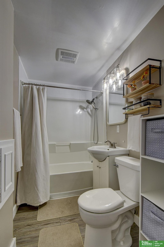 full bathroom with shower / bath combo with shower curtain, hardwood / wood-style floors, toilet, and vanity