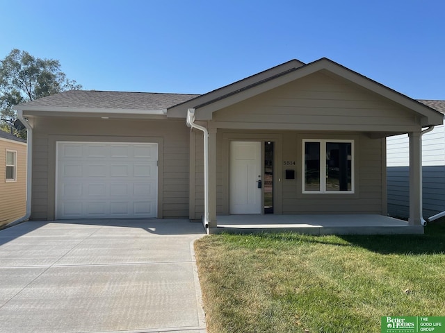 ranch-style house featuring a garage, a front yard, and covered porch