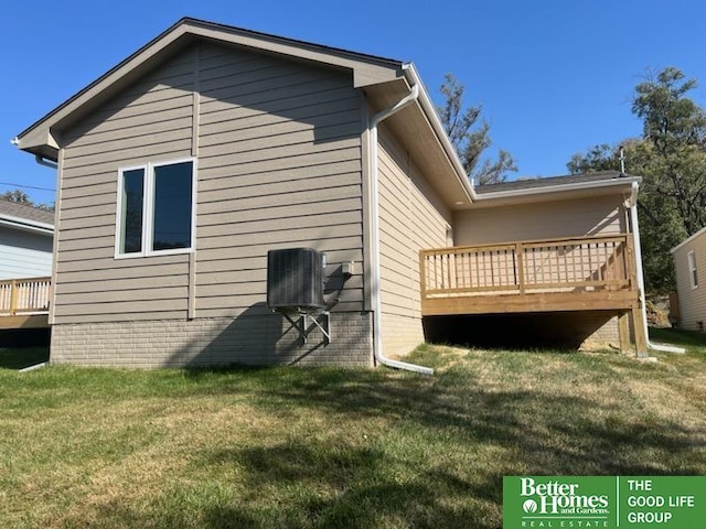 view of property exterior with a wooden deck and a yard