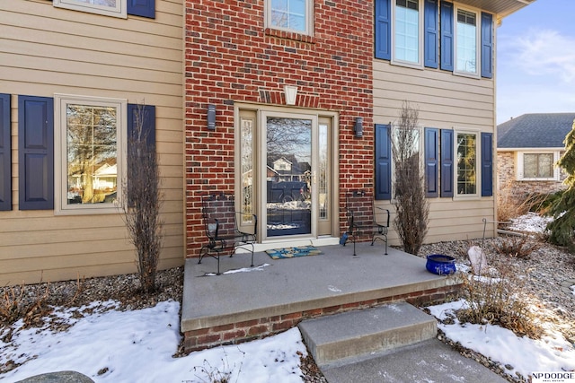 view of snow covered property entrance