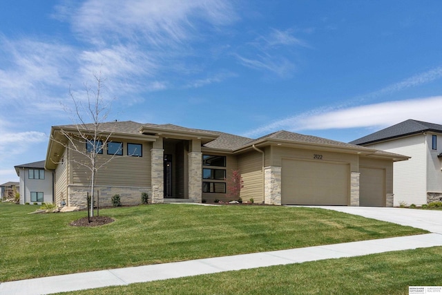 prairie-style home with a front lawn and a garage