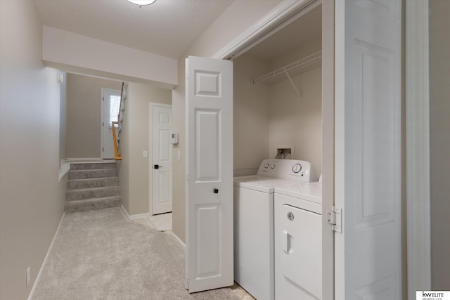 laundry room featuring light colored carpet and washer and dryer