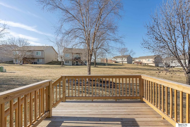 wooden terrace featuring a lawn