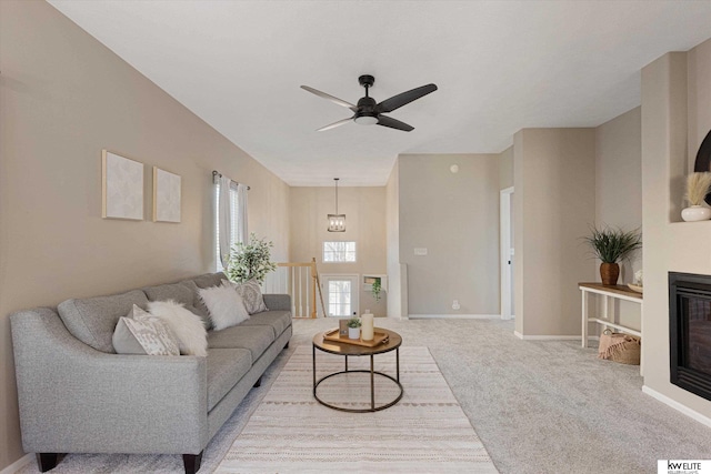 carpeted living room with ceiling fan