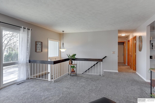 interior space featuring carpet floors and a textured ceiling