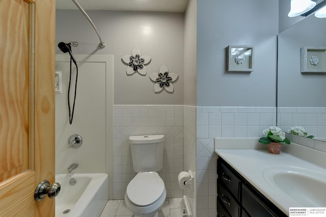 full bathroom with toilet, shower / tub combination, tile patterned flooring, tile walls, and vanity