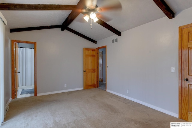 unfurnished bedroom featuring ceiling fan, light colored carpet, and vaulted ceiling with beams