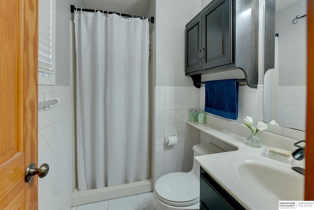 bathroom featuring toilet, vanity, tile walls, and a shower with shower curtain