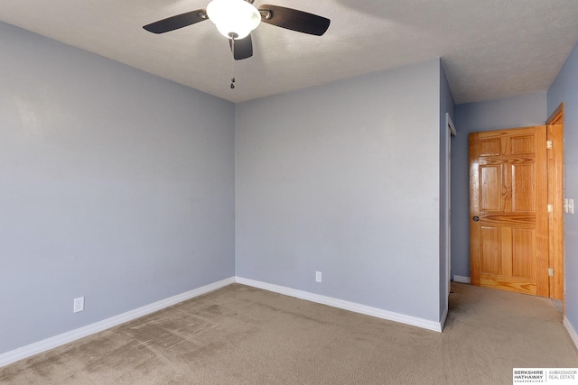 spare room with carpet floors and ceiling fan