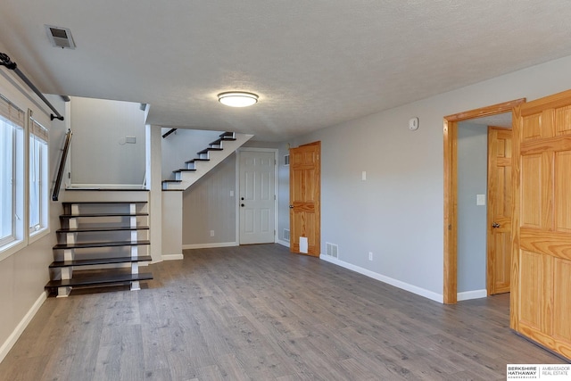 interior space with hardwood / wood-style flooring and a textured ceiling