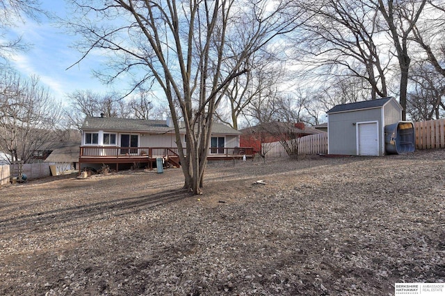 view of yard with an outbuilding, a deck, and a garage