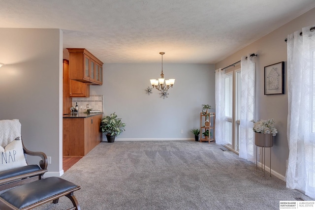 interior space featuring light carpet and a notable chandelier