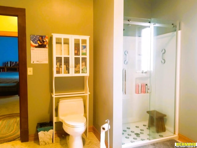 bathroom with toilet and walk in shower