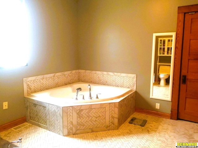 bathroom with toilet and a relaxing tiled tub