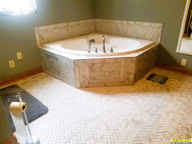 bathroom featuring tile patterned floors and a relaxing tiled tub