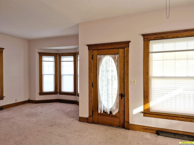 carpeted entryway featuring a baseboard radiator