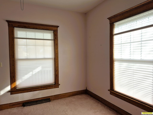 carpeted spare room with plenty of natural light