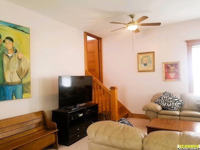 living room with ceiling fan and light colored carpet