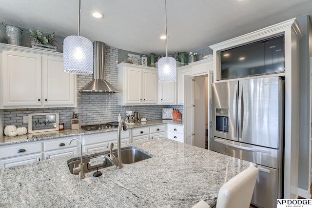 kitchen with tasteful backsplash, appliances with stainless steel finishes, white cabinets, and hanging light fixtures