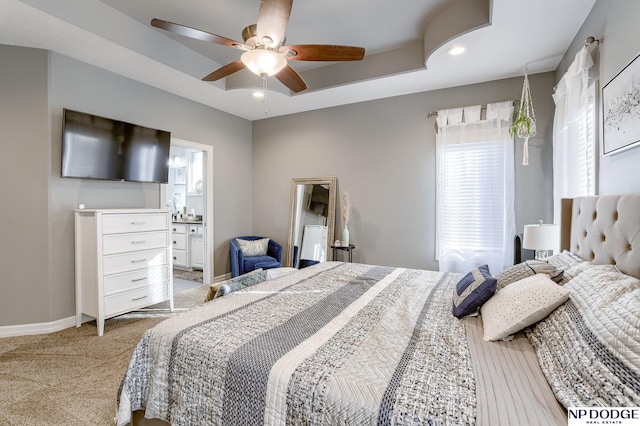 carpeted bedroom featuring ceiling fan and ensuite bathroom