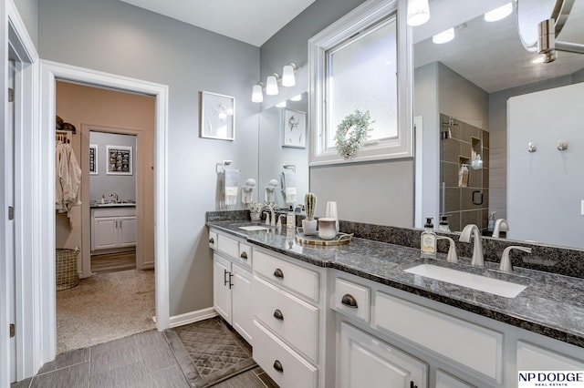 bathroom featuring walk in shower and vanity