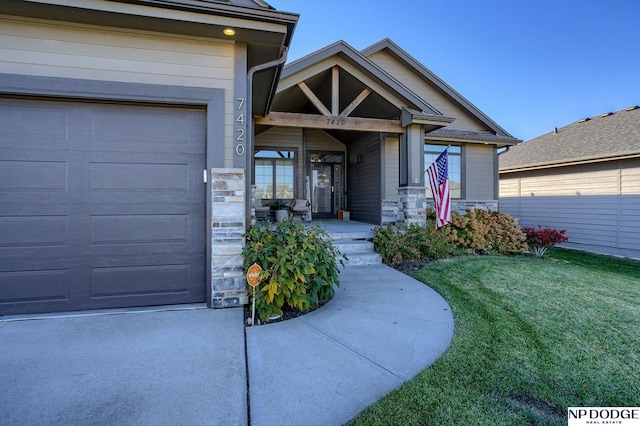 property entrance with a yard and a garage