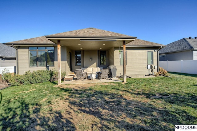 rear view of house with a yard and a patio