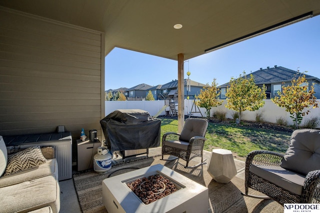 view of patio / terrace with grilling area and an outdoor living space with a fire pit