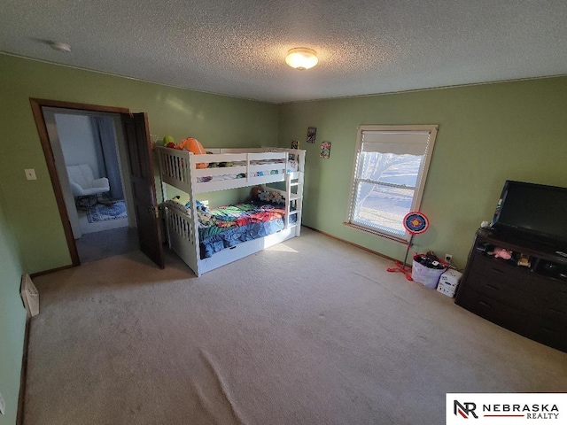 unfurnished bedroom with light colored carpet and a textured ceiling