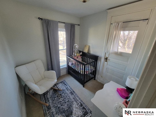 bedroom featuring a nursery area