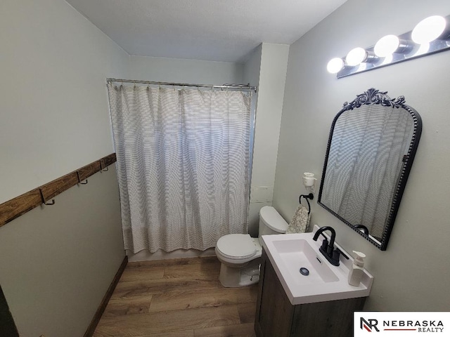 full bathroom featuring hardwood / wood-style floors, toilet, vanity, and shower / tub combo with curtain