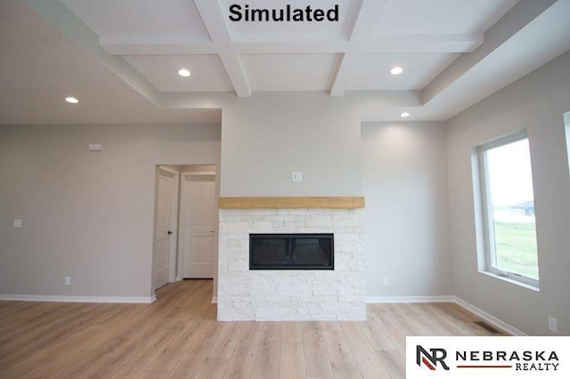 unfurnished living room with coffered ceiling, beam ceiling, a fireplace, and light hardwood / wood-style flooring