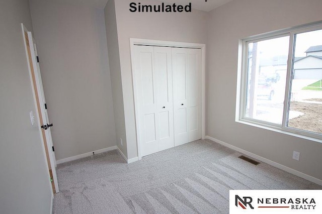 unfurnished bedroom with light carpet and a closet