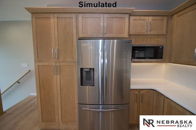 kitchen with stainless steel fridge, black microwave, and light hardwood / wood-style flooring