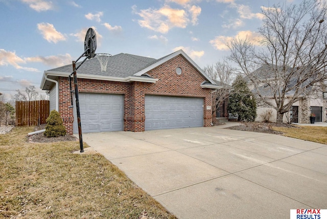 exterior space featuring brick siding, driveway, an attached garage, and roof with shingles