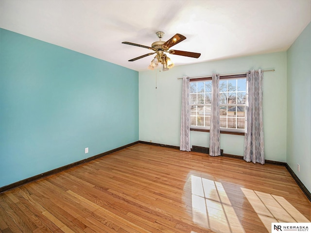 spare room featuring light wood-type flooring and ceiling fan