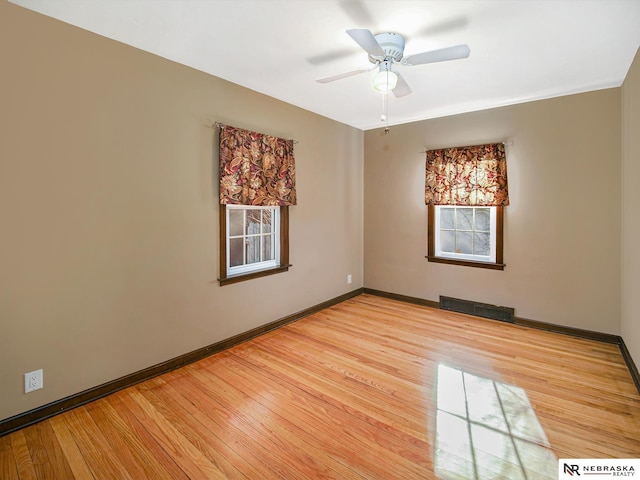 empty room with ceiling fan and light wood-type flooring