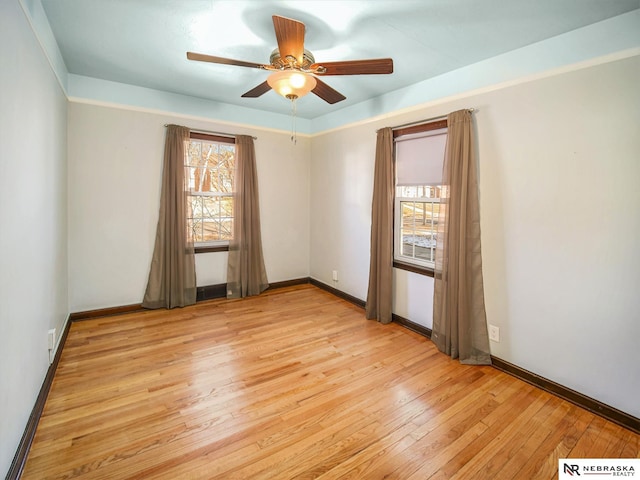 empty room featuring ceiling fan and light hardwood / wood-style flooring