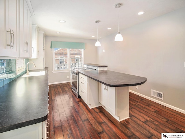 kitchen featuring white cabinetry, sink, a center island, and electric stove