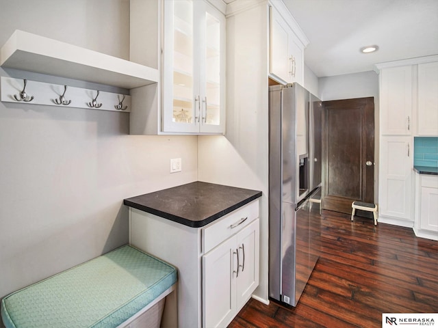 kitchen featuring stainless steel refrigerator with ice dispenser, dark hardwood / wood-style flooring, and white cabinets