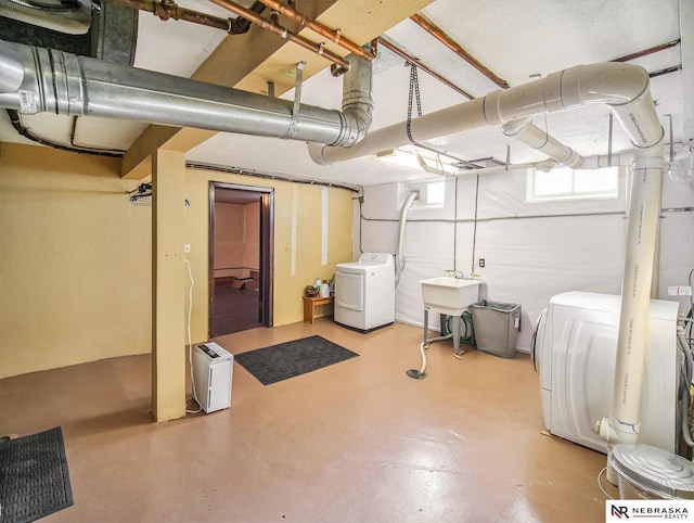 basement with sink and washer and clothes dryer