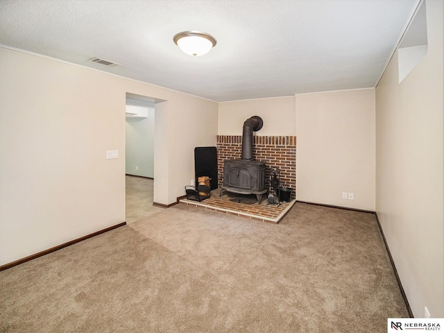 unfurnished living room with light carpet and a wood stove