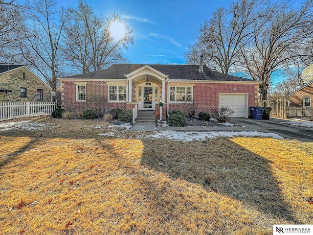 ranch-style house with a garage and a front yard