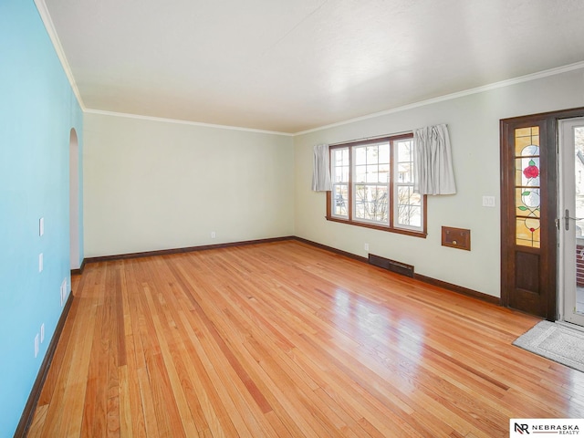 interior space featuring light wood-type flooring and ornamental molding