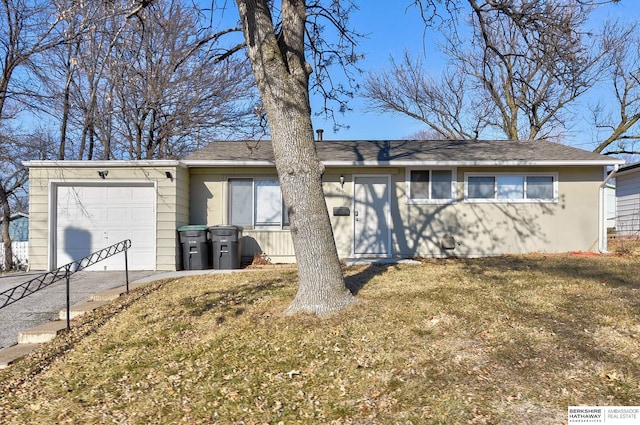 single story home featuring a garage and a front lawn