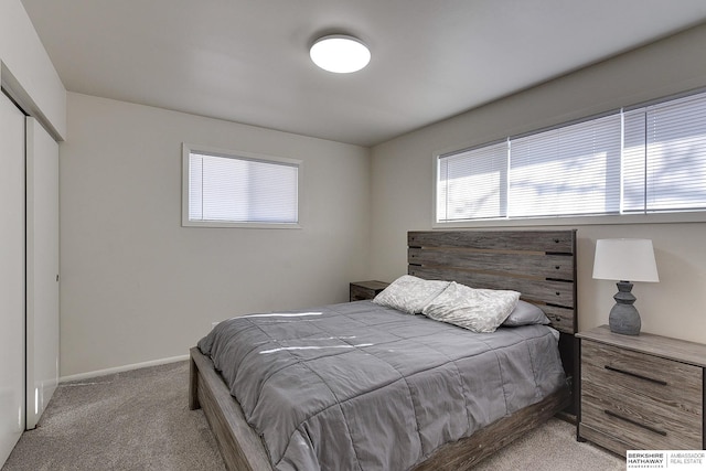 bedroom featuring light carpet and a closet